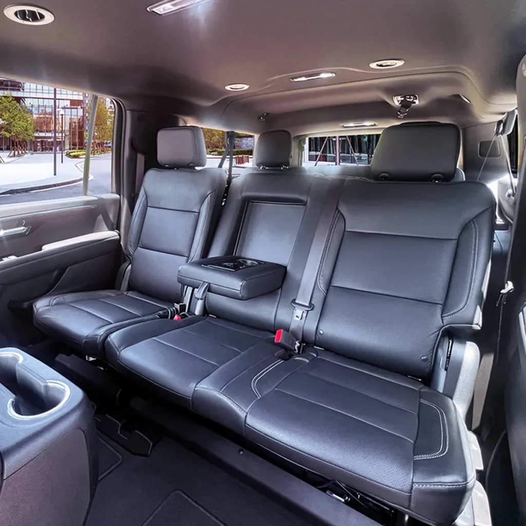 SUV-Suburban third row leather bench seat with fold-down armrest.