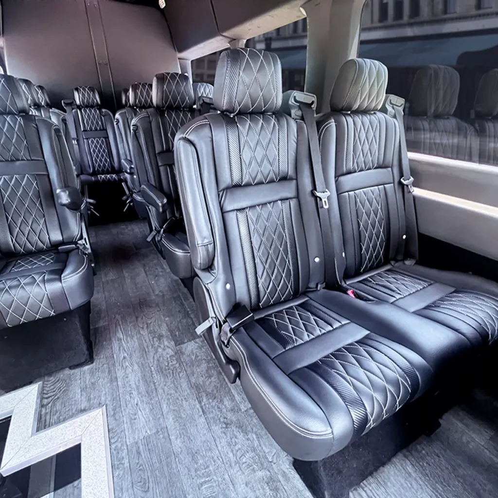 Close-up of diamond stitched leather captain's chairs in a Transit Van.