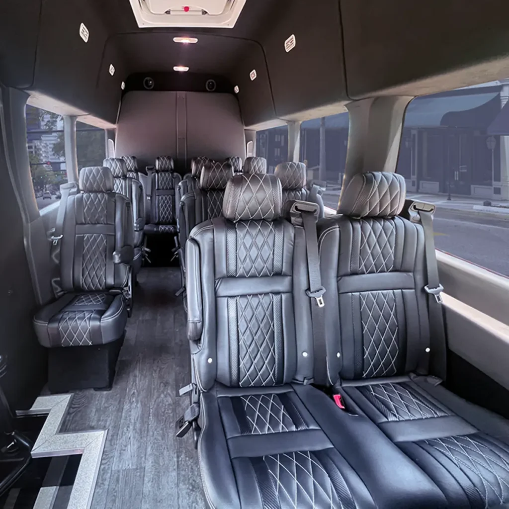 Transit Van interior with diamond stitched leather seats and exit door.