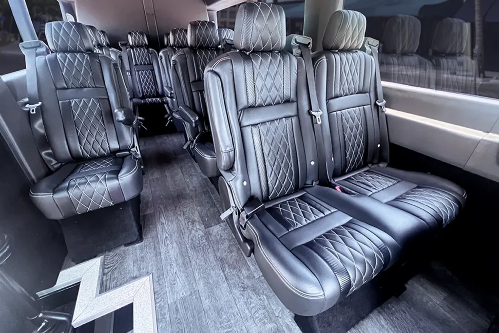 Close-up of diamond stitched leather captain's chairs in a Transit Van.