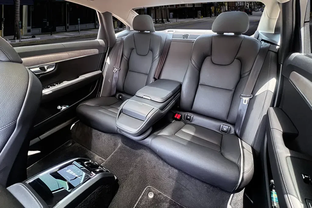 Sedan rear leather seats with rear-seat control panel visible.