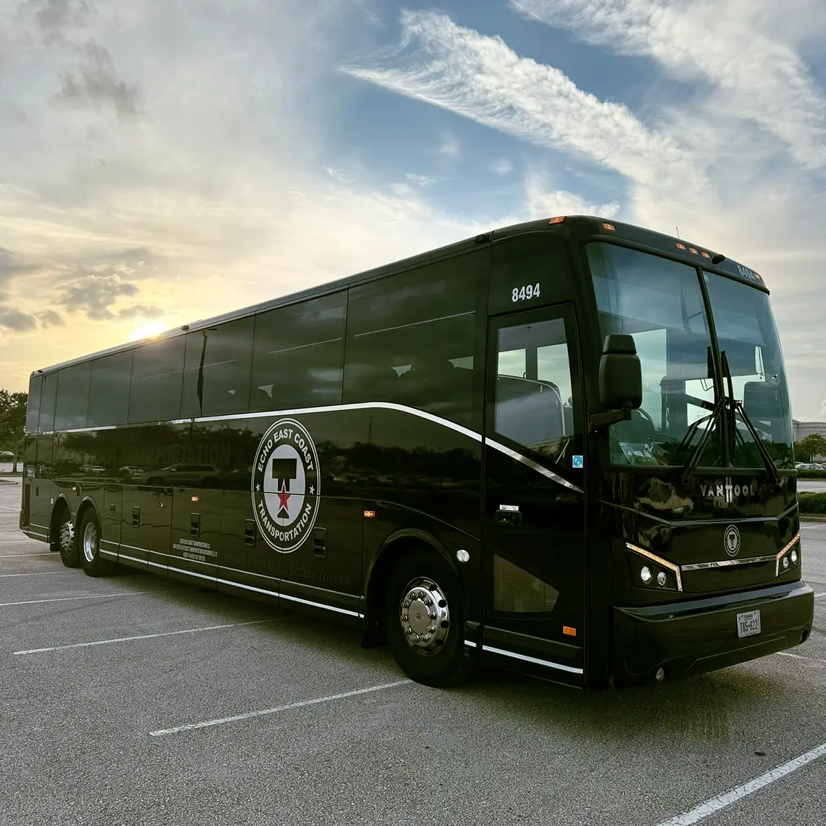 Echo East Coast Transportation motorcoach parked at sunset.