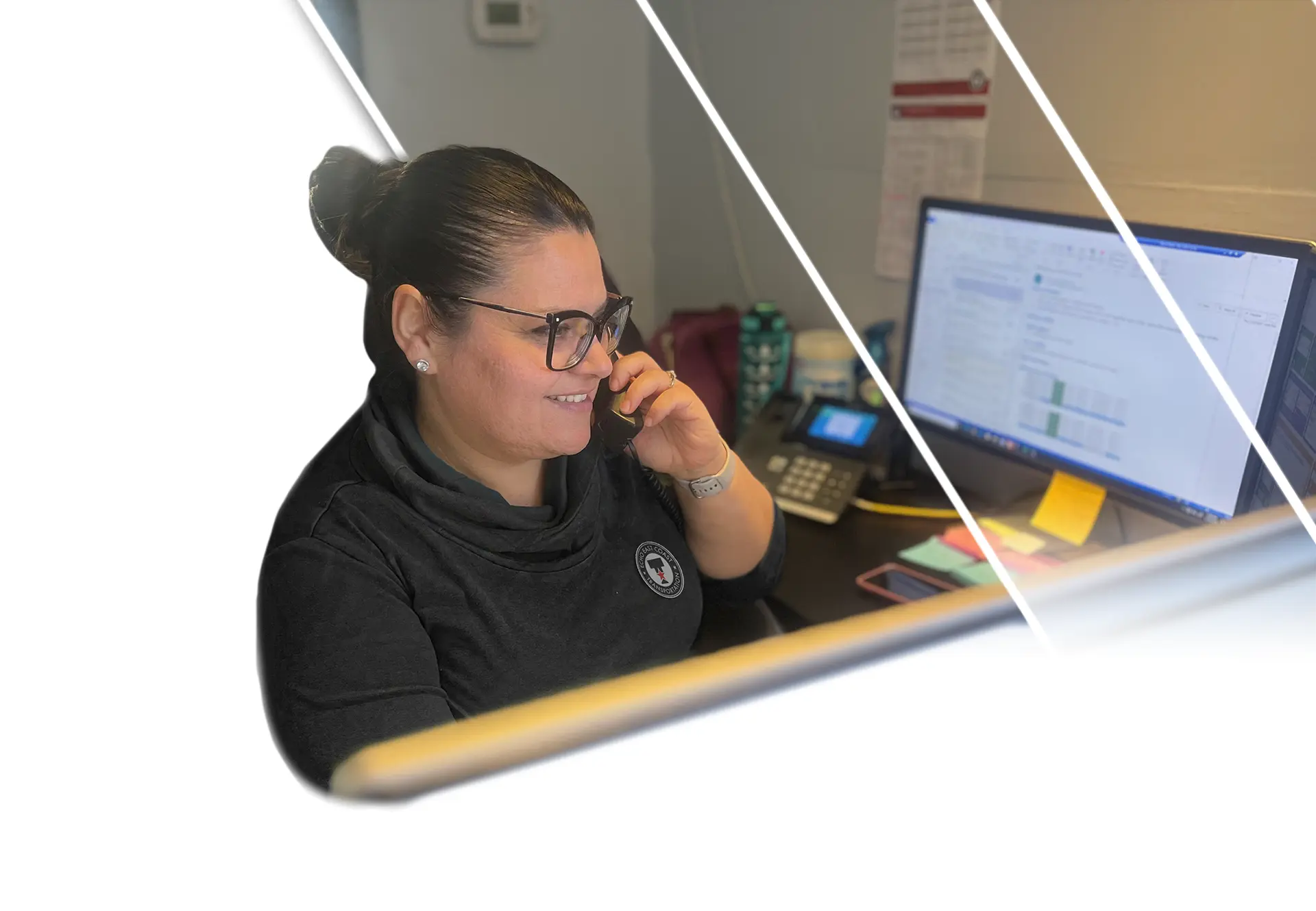 Echo East Coast Transportation employee answering the phone at her office desk.